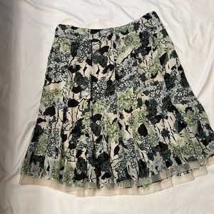 Skirt made out of 100% polyester. I’ve even worn with tank top and tennis shoes!